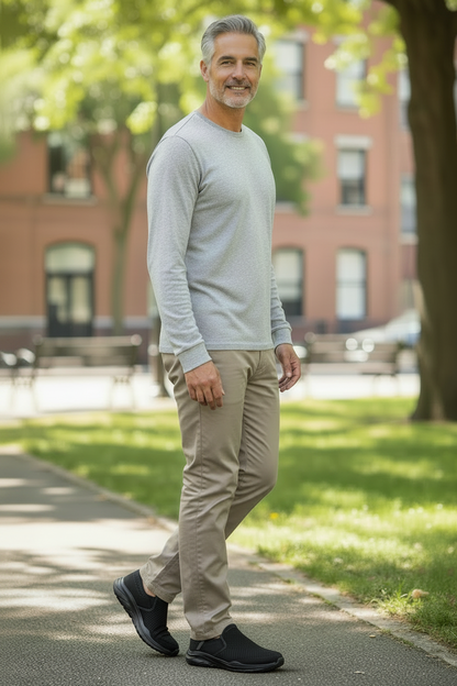 Older male model in baggy taupe chinos with black Skechers Slip-ins